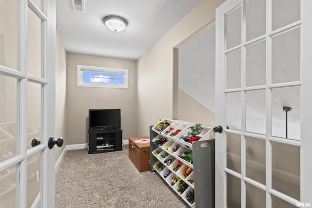 rec room with carpet, visible vents, french doors, and baseboards