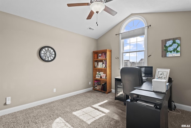 carpeted office featuring visible vents, a ceiling fan, baseboards, and vaulted ceiling