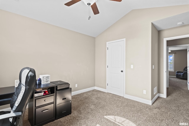 carpeted office space with baseboards, ceiling fan, and vaulted ceiling