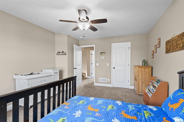 carpeted bedroom with visible vents, baseboards, and a ceiling fan