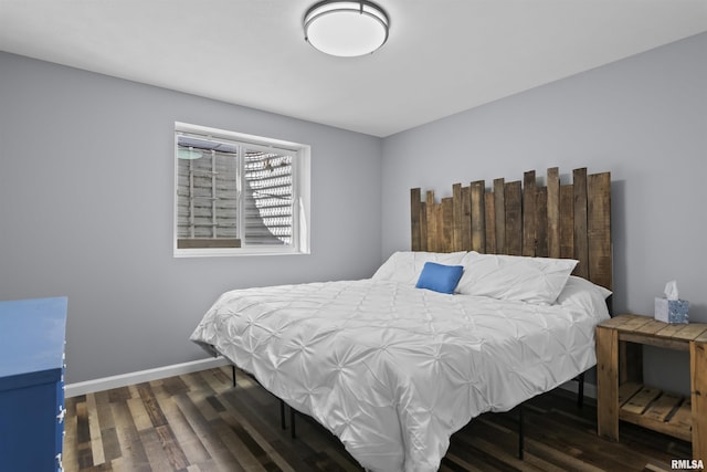 bedroom with wood finished floors and baseboards