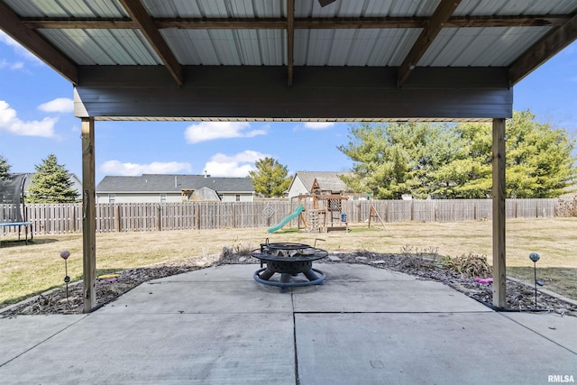 view of patio / terrace with a fenced backyard, a playground, and a trampoline