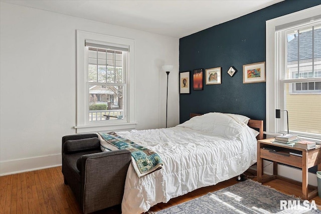 bedroom featuring baseboards and wood finished floors