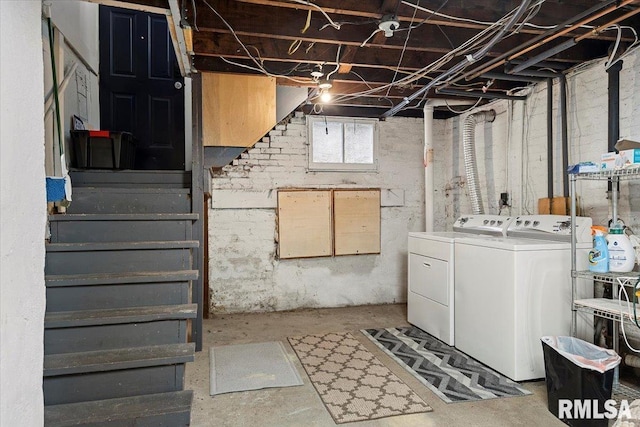 below grade area featuring stairway and washer and clothes dryer