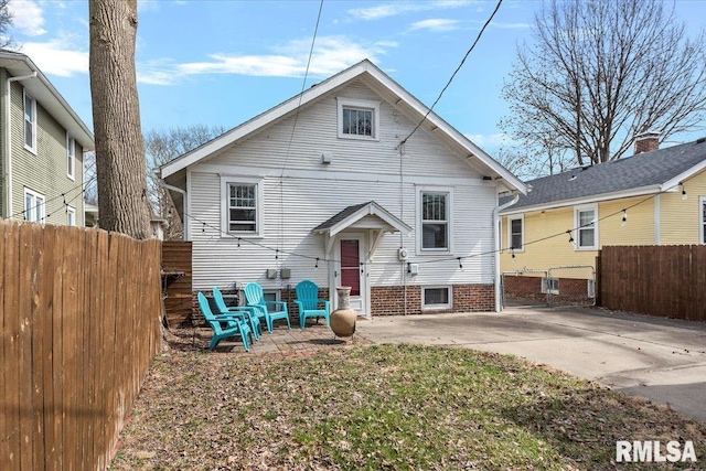 view of front of house with a patio area and fence