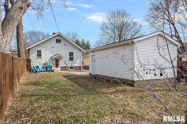 rear view of house with a yard, a patio area, and a fenced backyard