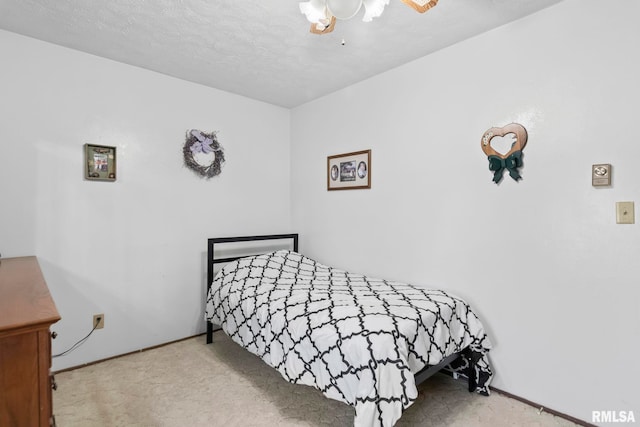 bedroom featuring carpet and a textured ceiling