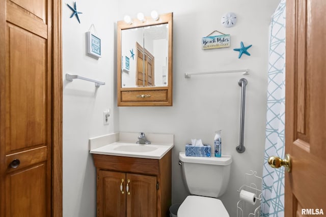 bathroom with toilet and vanity