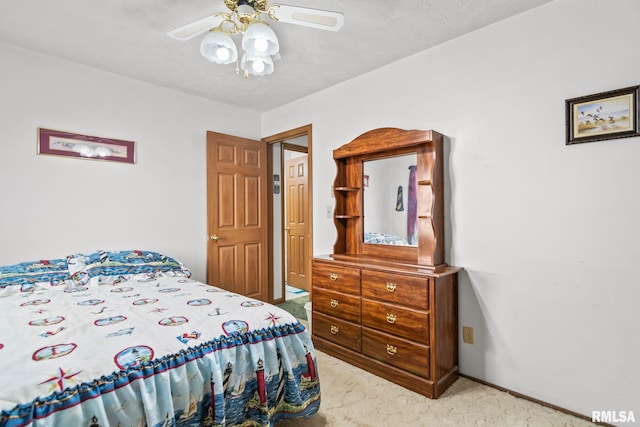 bedroom with a ceiling fan and carpet flooring