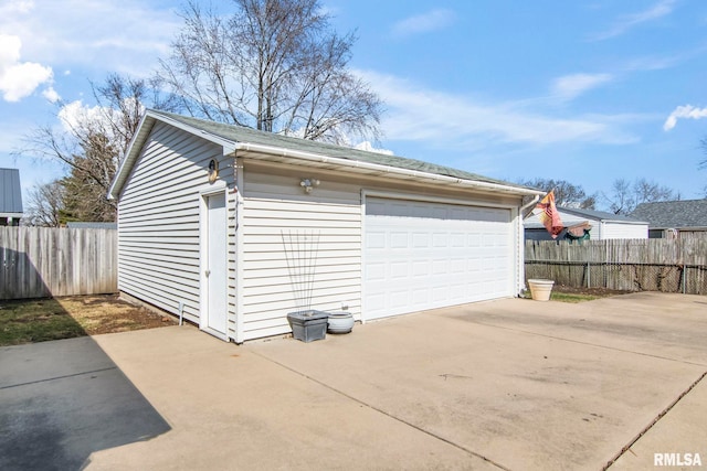 detached garage featuring fence