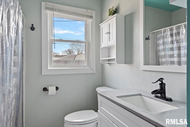 bathroom with a shower with shower curtain, toilet, and vanity