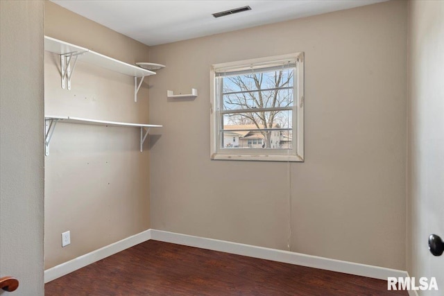 walk in closet featuring wood finished floors and visible vents