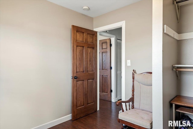 living area featuring dark wood finished floors and baseboards