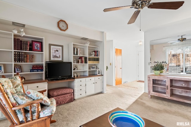 carpeted living room with a ceiling fan