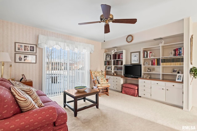 living room featuring carpet, ceiling fan, and wallpapered walls