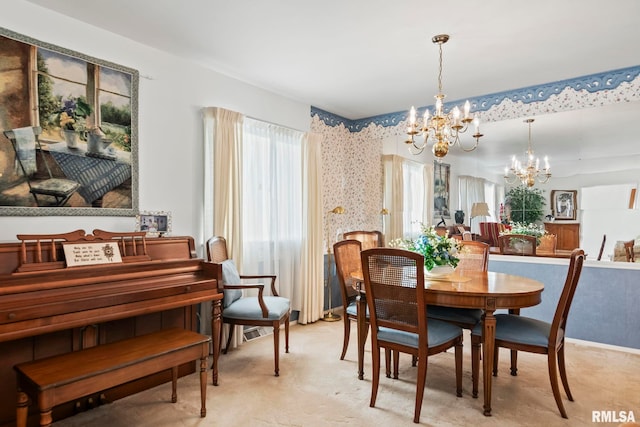 dining space with wallpapered walls, a notable chandelier, and light carpet