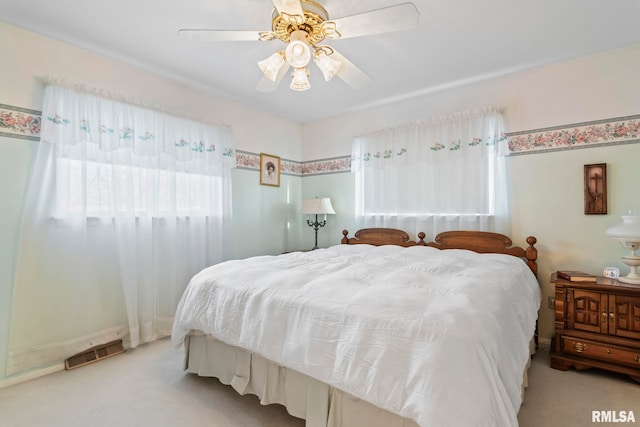 bedroom with visible vents, carpet flooring, and ceiling fan