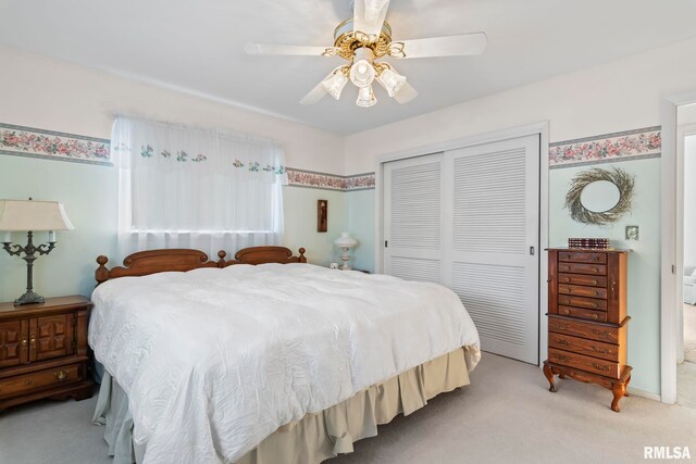 bedroom featuring a closet, light carpet, and a ceiling fan