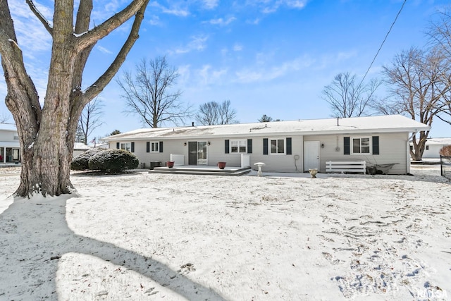 view of snow covered rear of property