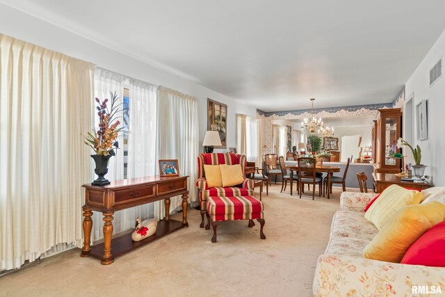 carpeted living area with a wealth of natural light, visible vents, and an inviting chandelier