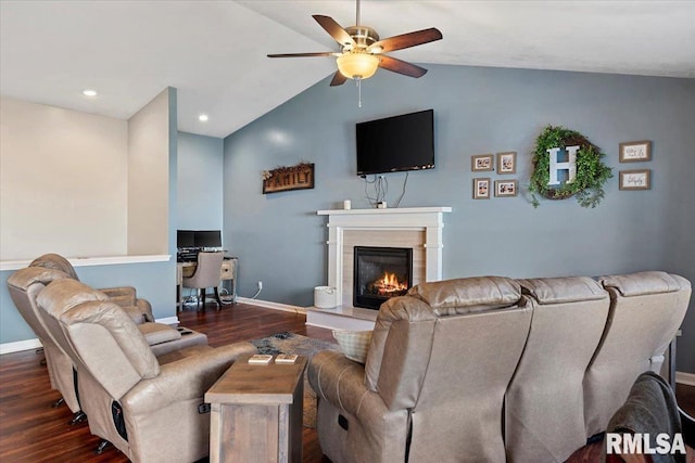 living room with a glass covered fireplace, lofted ceiling, ceiling fan, and wood finished floors