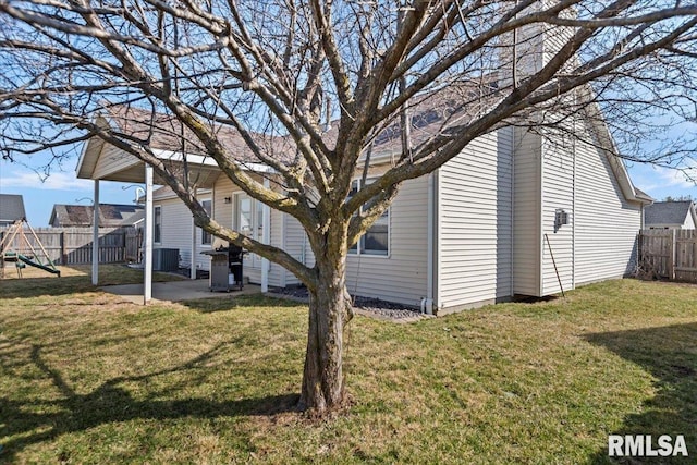 exterior space with a patio area, a playground, a yard, and fence