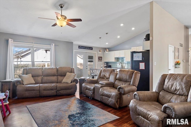 living area with french doors, high vaulted ceiling, ceiling fan, and dark wood-style flooring