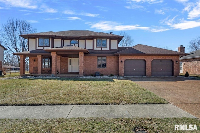 prairie-style house with brick siding, an attached garage, concrete driveway, and a front lawn