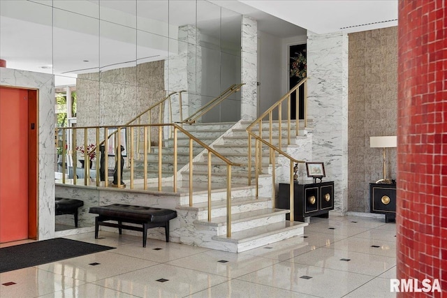 stairway with tile patterned floors and elevator