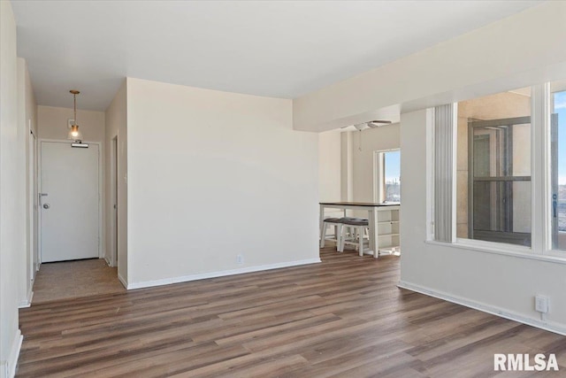 unfurnished room featuring baseboards and wood finished floors