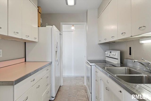 kitchen featuring a sink, white appliances, and white cabinets