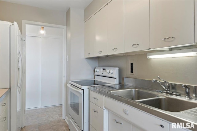 kitchen featuring a sink, white appliances, white cabinetry, and stainless steel counters