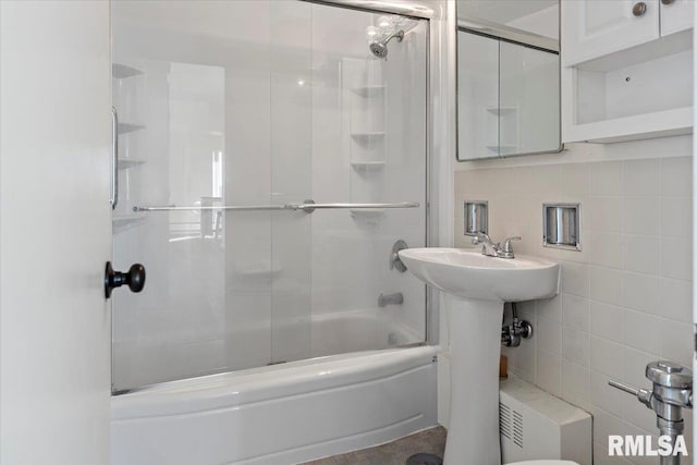 full bathroom featuring enclosed tub / shower combo, decorative backsplash, and tile walls