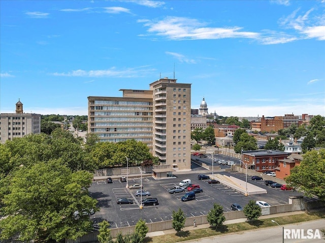 view of property featuring a view of city and uncovered parking