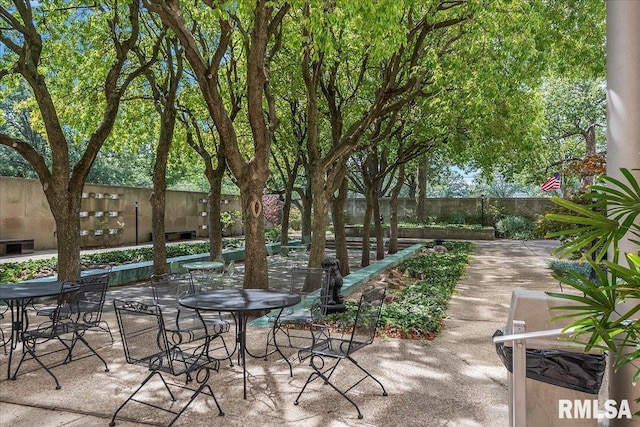 view of patio featuring outdoor dining space and fence