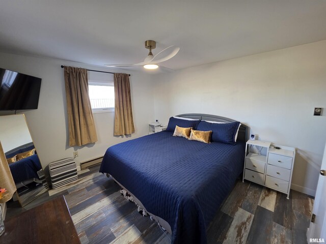 bedroom with baseboards, a baseboard heating unit, a ceiling fan, and wood finished floors