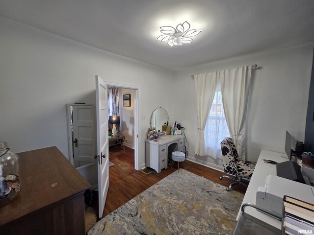 bedroom with baseboards and dark wood-style flooring