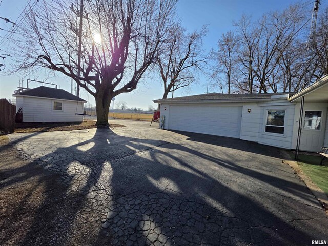 exterior space featuring an outbuilding and fence