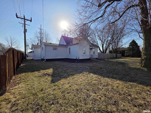 exterior space with a lawn and fence