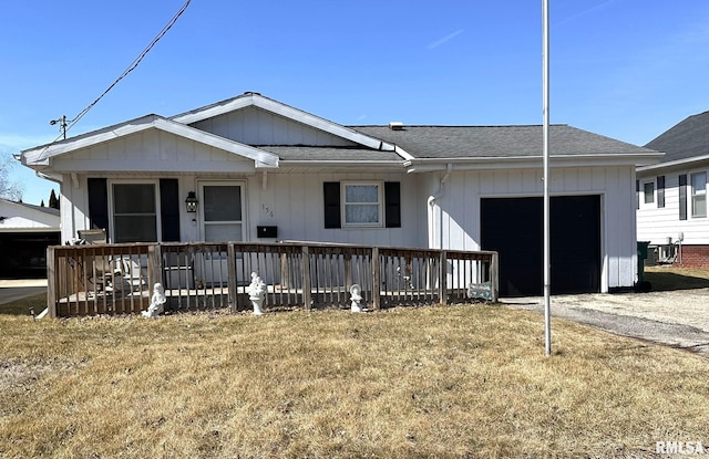 view of front facade featuring driveway, a porch, an attached garage, central AC, and a shingled roof