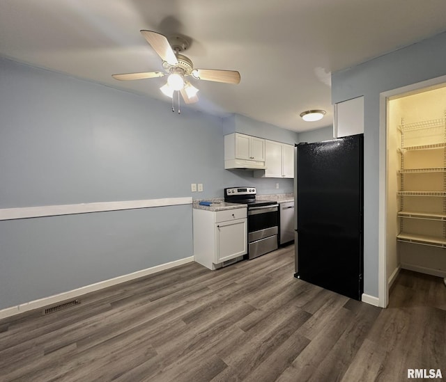 kitchen featuring white cabinetry, electric range, visible vents, and freestanding refrigerator