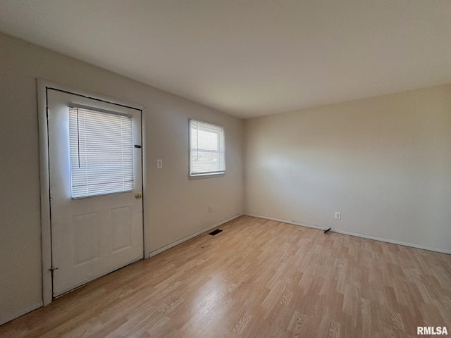 interior space featuring light wood finished floors and baseboards