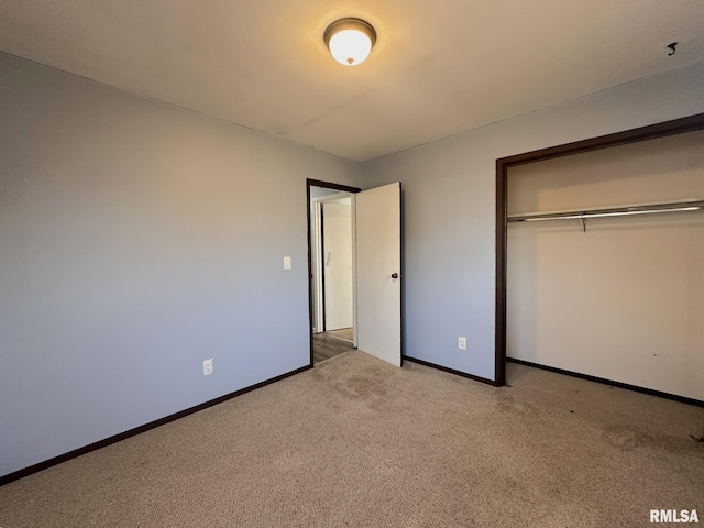 unfurnished bedroom with a closet, baseboards, and carpet