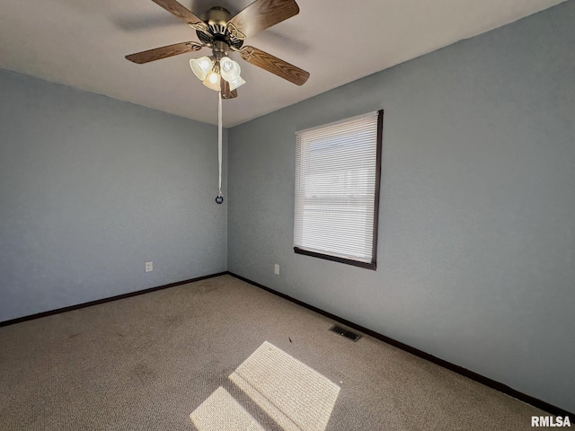 empty room with visible vents, light carpet, baseboards, and a ceiling fan