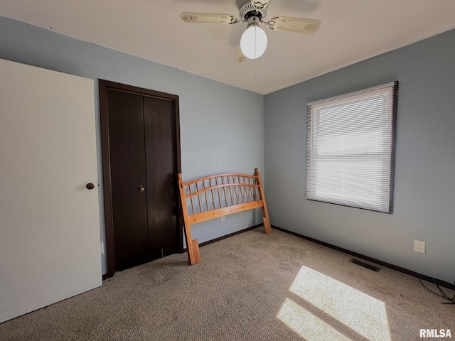 bedroom featuring carpet, visible vents, baseboards, ceiling fan, and a closet