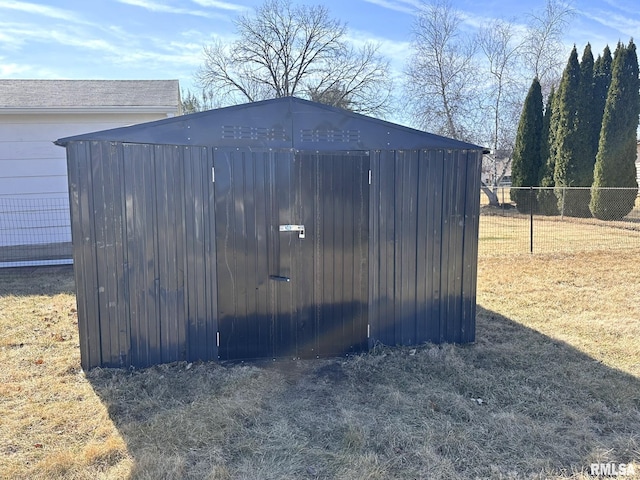 view of outbuilding with an outdoor structure and fence