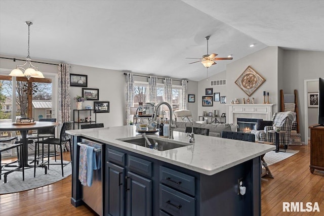 kitchen with visible vents, ceiling fan, a sink, stainless steel dishwasher, and blue cabinets