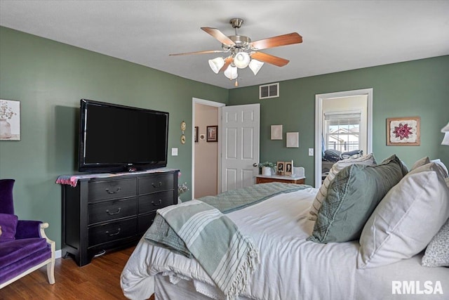 bedroom with visible vents, ceiling fan, and wood finished floors