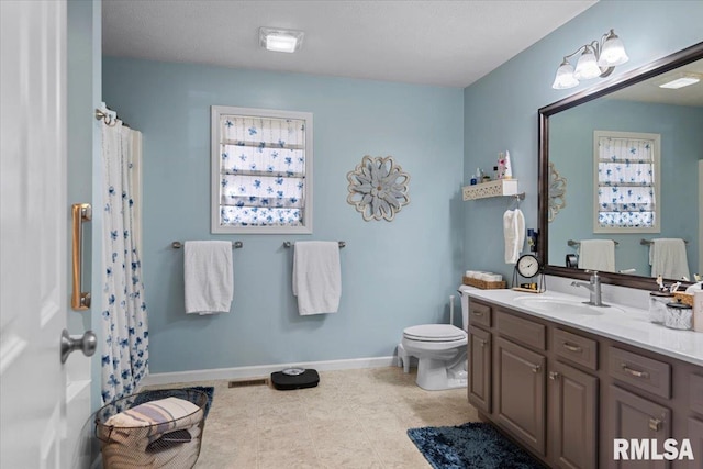 bathroom with visible vents, toilet, vanity, and baseboards