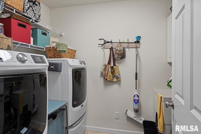 laundry area with washer and dryer and cabinet space